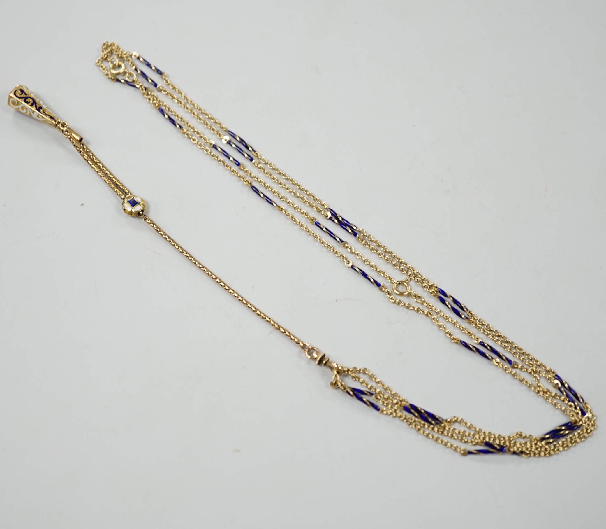 An early 20th century yellow metal overlaid, two colour enamel and citrine set watch key, on a 585 yellow metal and two colour enamel twin strand albertina, overall 88cm, gross weight 21.5 grams.